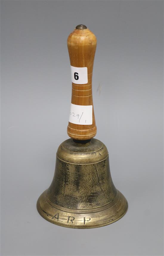 A hand bell marked A.R.P. length 25cm